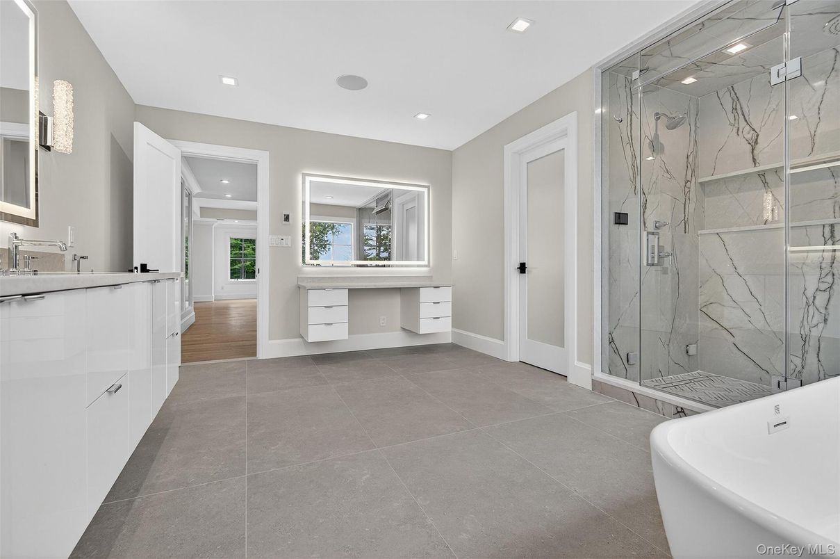 Bathroom, Dual Sink Vanities, Free Standing Baths, Glass Shower, Interior, Marble Walls, Recessed Lighting