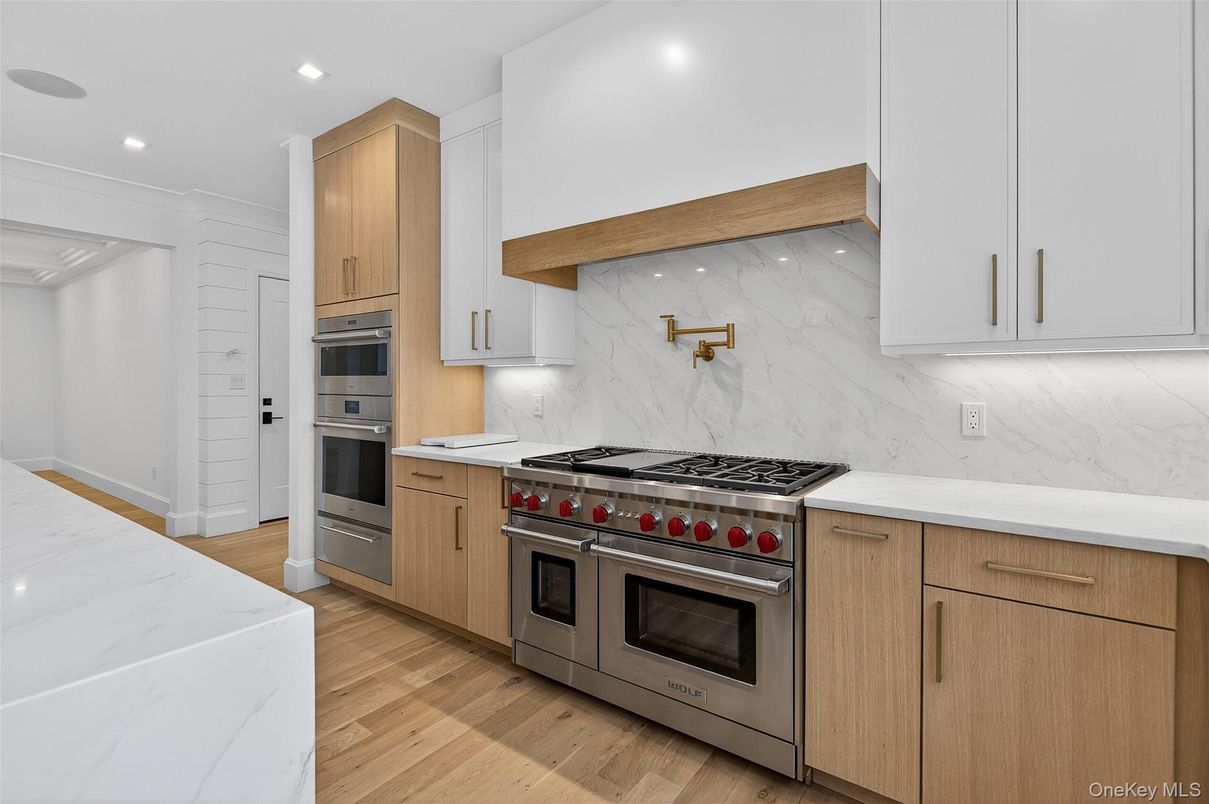 Interior, Kitchen, Marble Walls, Recessed Lighting, Stainless Steel Appliances, Wood Texture Flooring