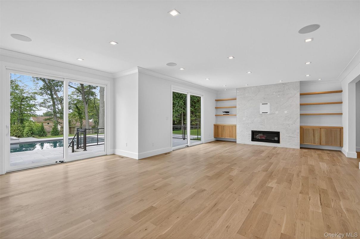 Empty room, Fireplace, Interior, Marble Walls, Recessed Lighting, Wood Texture Flooring