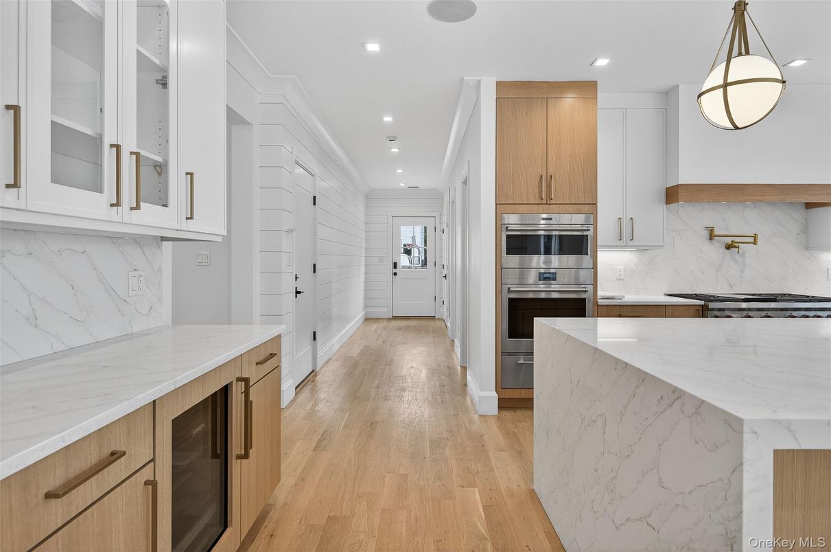 Interior, Kitchen, Marble Walls, Pendant Lights, Recessed Lighting, Stainless Steel Appliances, Wood Texture Flooring