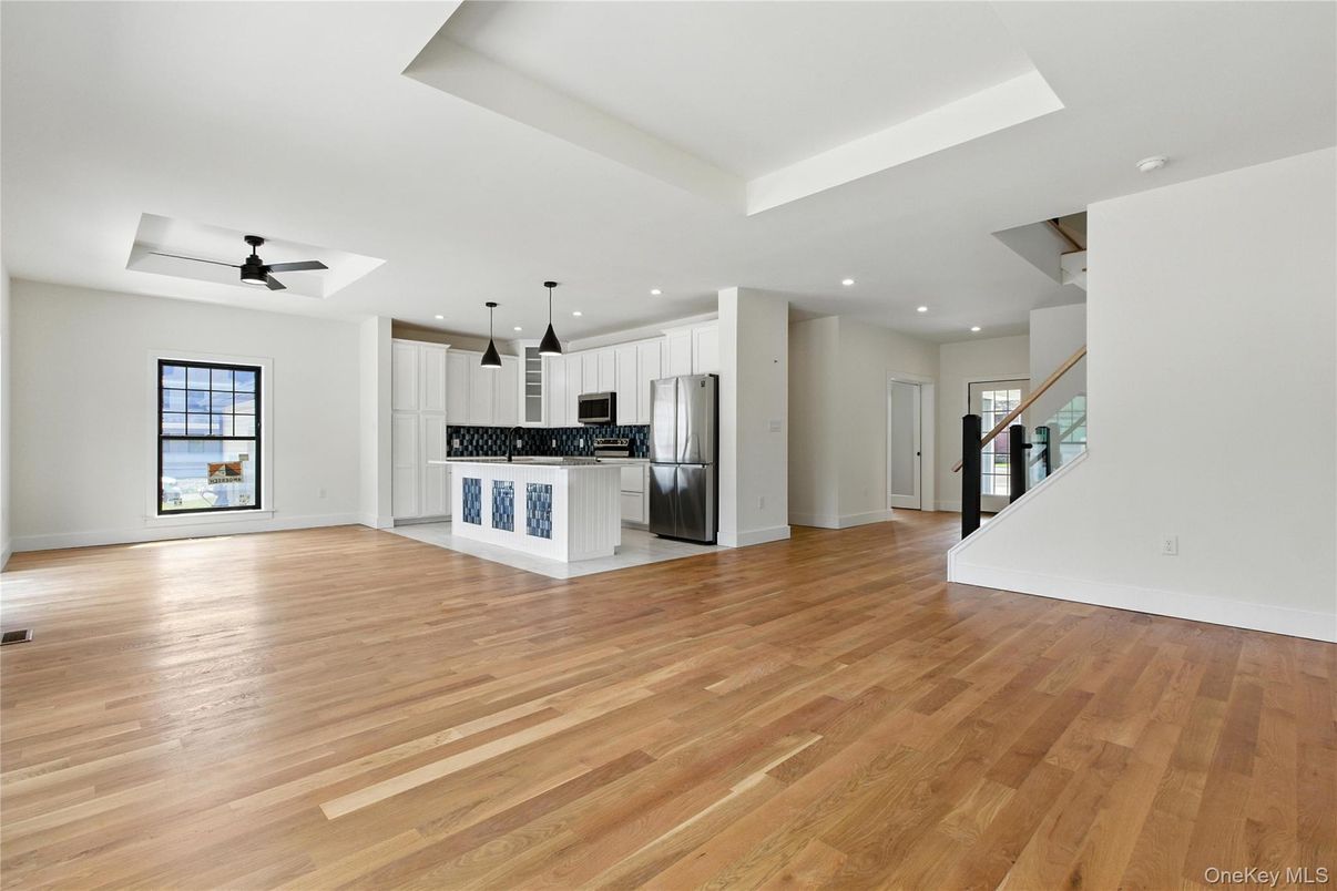 Empty room, Interior, Kitchen, Pendant Lights, Recessed Lighting, Stainless Steel Appliances, Wood Texture Flooring