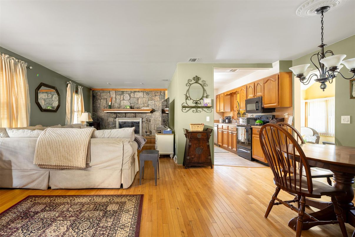 Chandelier, Dining room, Fireplace, Interior, Kitchen, Living room, Pendant Lights, Stone Walls, Wood Texture Flooring