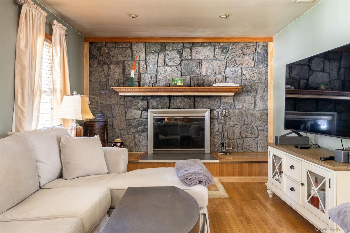 Fireplace, Interior, Living room, Recessed Lighting, Stone Walls, Wood Texture Flooring