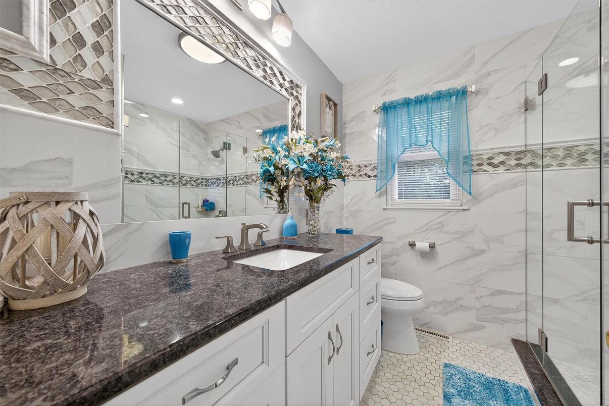 Bathroom, Dual Sink Vanities, Glass Shower, Interior, Marble Walls, Recessed Lighting