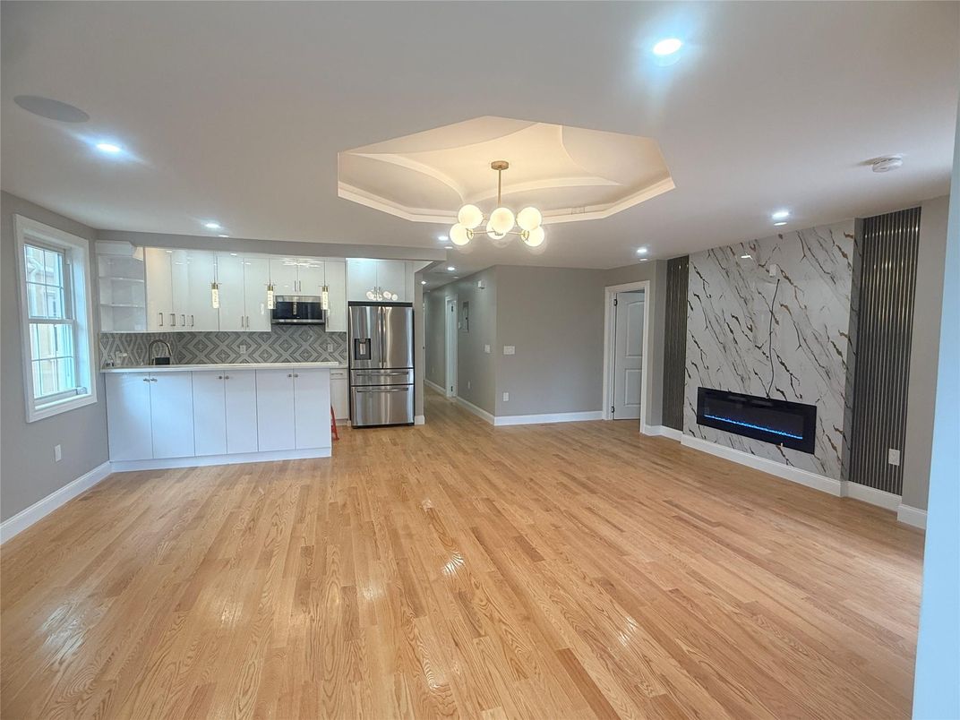 Fireplace, Interior, Kitchen, Marble Walls, Pendant Lights, Recessed Lighting, Stainless Steel Appliances, Wood Texture Flooring