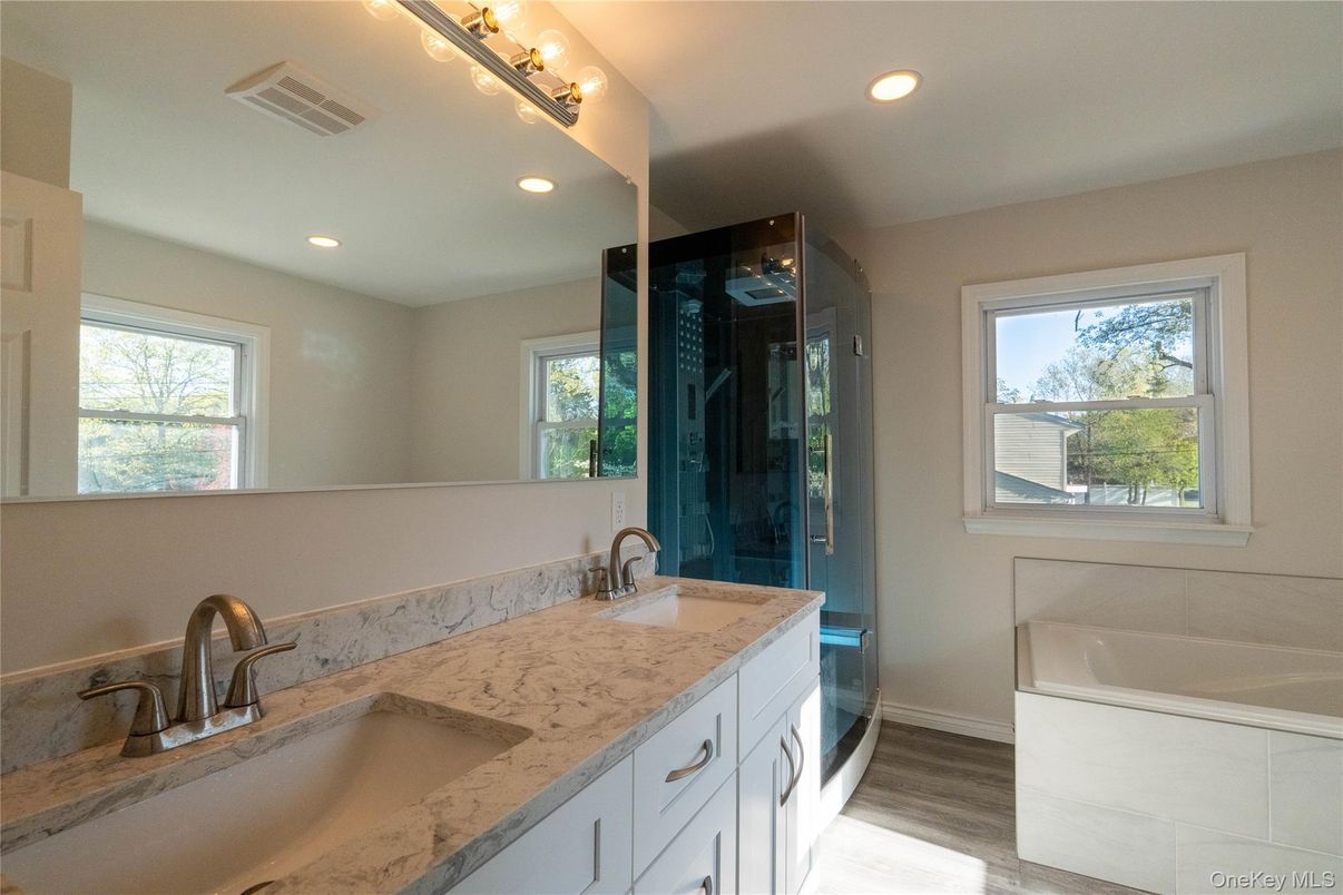Bathroom, Dual Sink Vanities, Glass Shower, Interior, Recessed Lighting, Wood Texture Flooring
