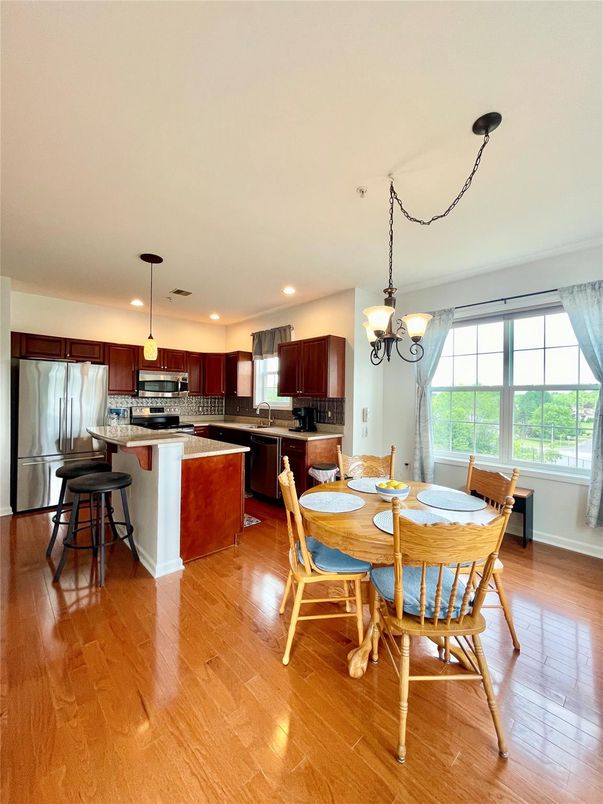 Chandelier, Dining room, Interior, Kitchen, Pendant Lights, Recessed Lighting, Stainless Steel Appliances, Wood Texture Flooring