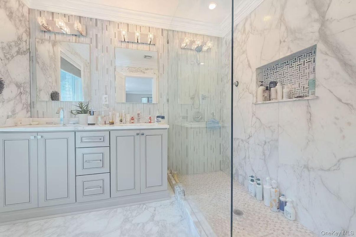 Bathroom, Dual Sink Vanities, Glass Shower, Interior, Marble, Marble Walls, Recessed Lighting