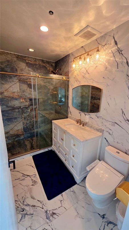 Bathroom, Dual Sink Vanities, Glass Shower, Interior, Marble, Marble Walls, Recessed Lighting