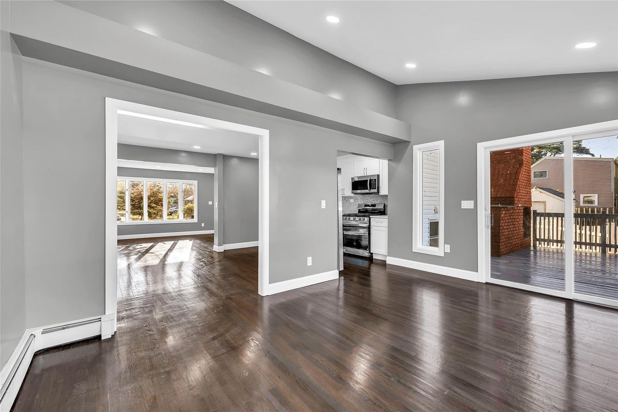 Empty room, Interior, Kitchen, Recessed Lighting, Stainless Steel Appliances, Wood Texture Flooring