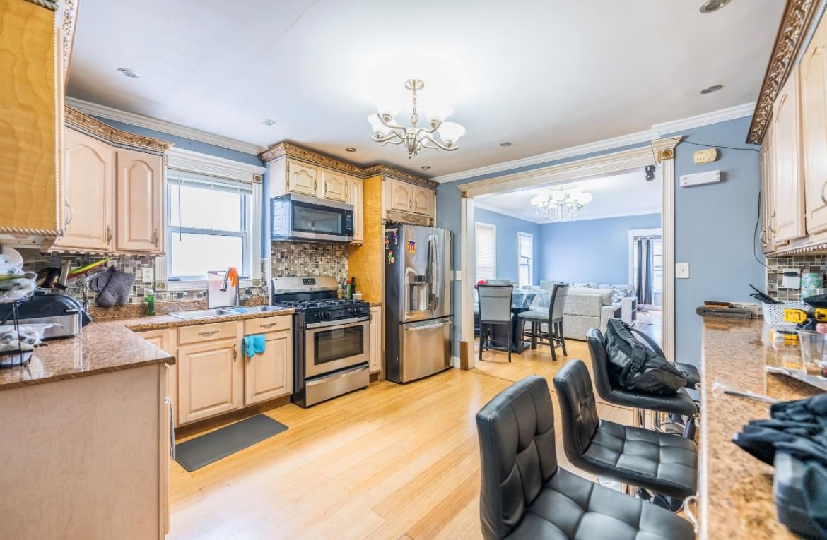 Chandelier, Dining room, Interior, Kitchen, Recessed Lighting, Stainless Steel Appliances, Wood Texture Flooring