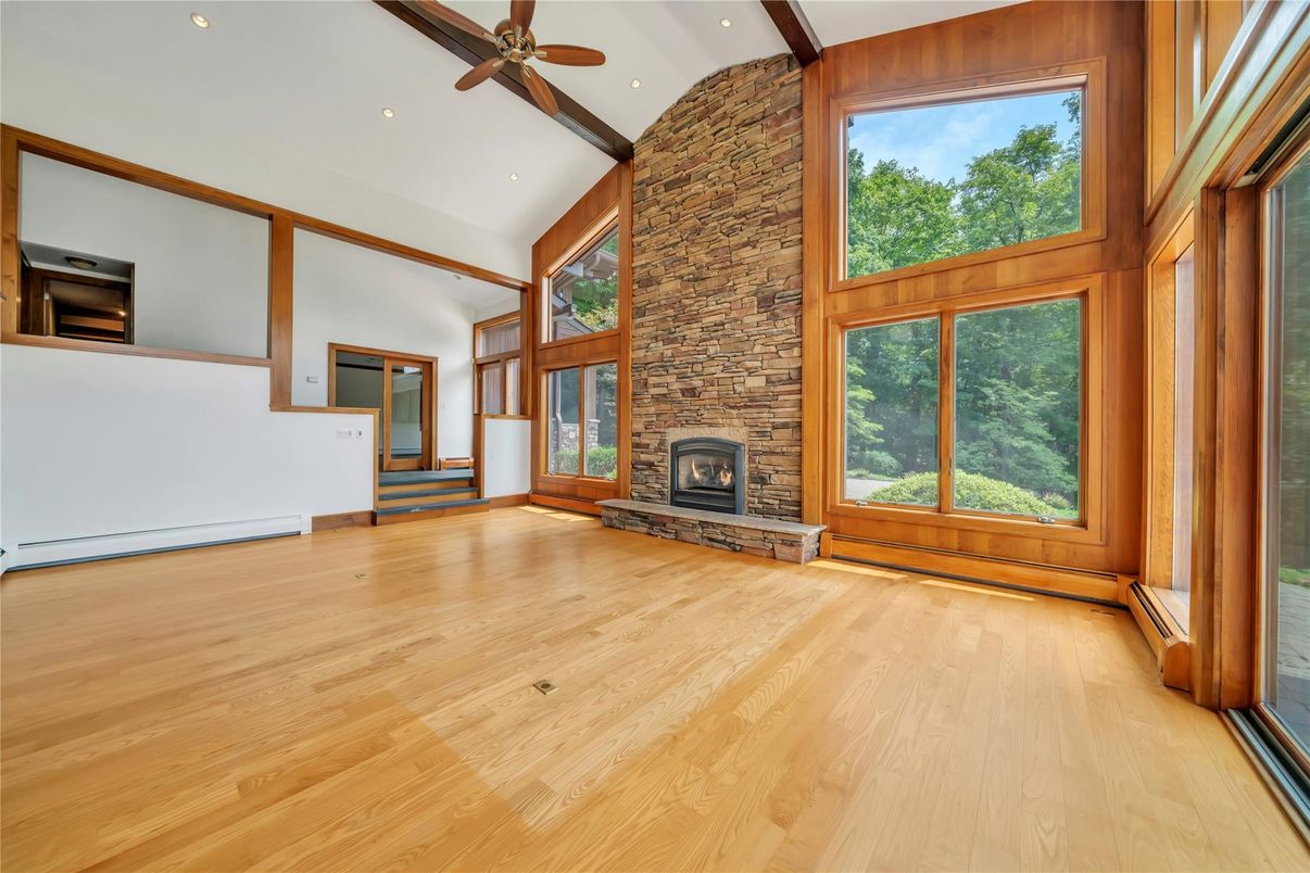 Empty room, Fireplace, Interior, Recessed Lighting, Stone Walls, Wood Texture Flooring