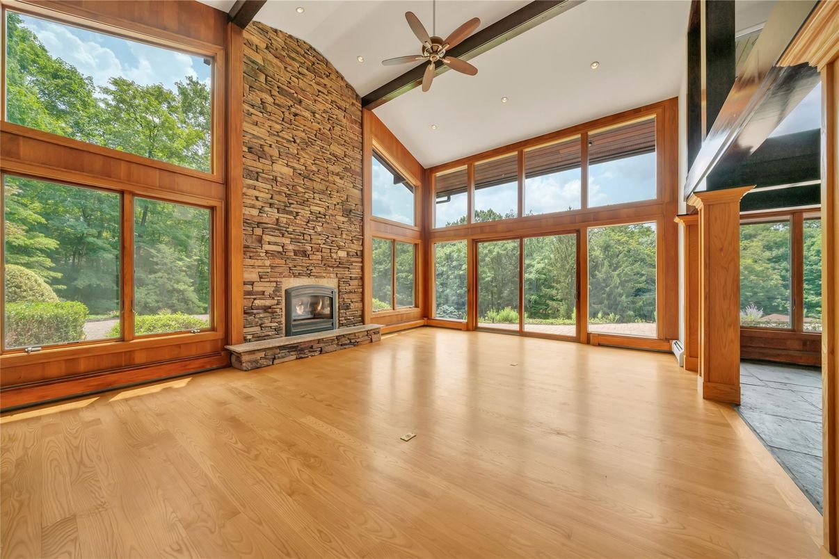 Empty room, Fireplace, Interior, Recessed Lighting, Stone Walls, Sun Room, Wood Texture Flooring