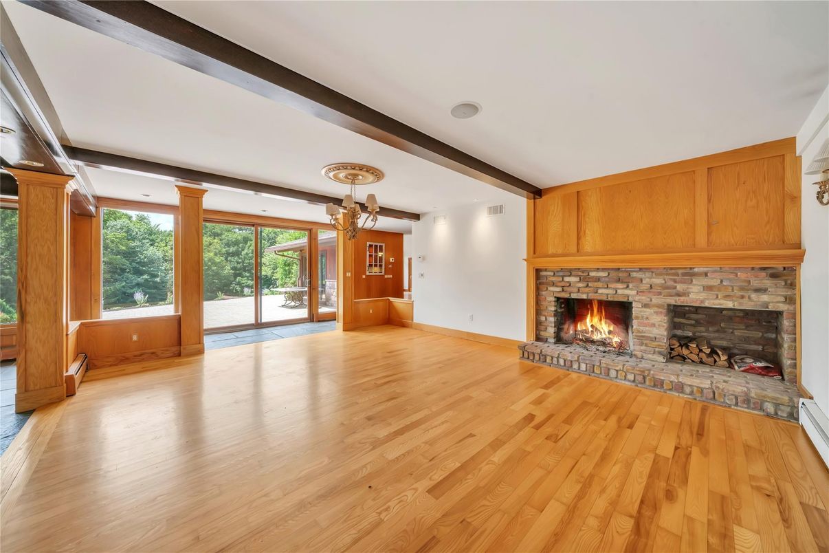 Chandelier, Empty room, Fireplace, Interior, Recessed Lighting, Wooden Beams, Wood Texture Flooring