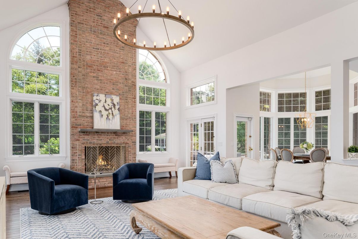 Chandelier, Dining room, Fireplace, Interior, Living room, Pendant Lights, Stone Walls, Wood Texture Flooring