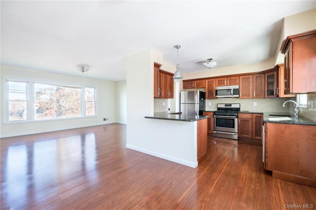 Empty room, Interior, Kitchen, Pendant Lights, Stainless Steel Appliances, Wood Texture Flooring