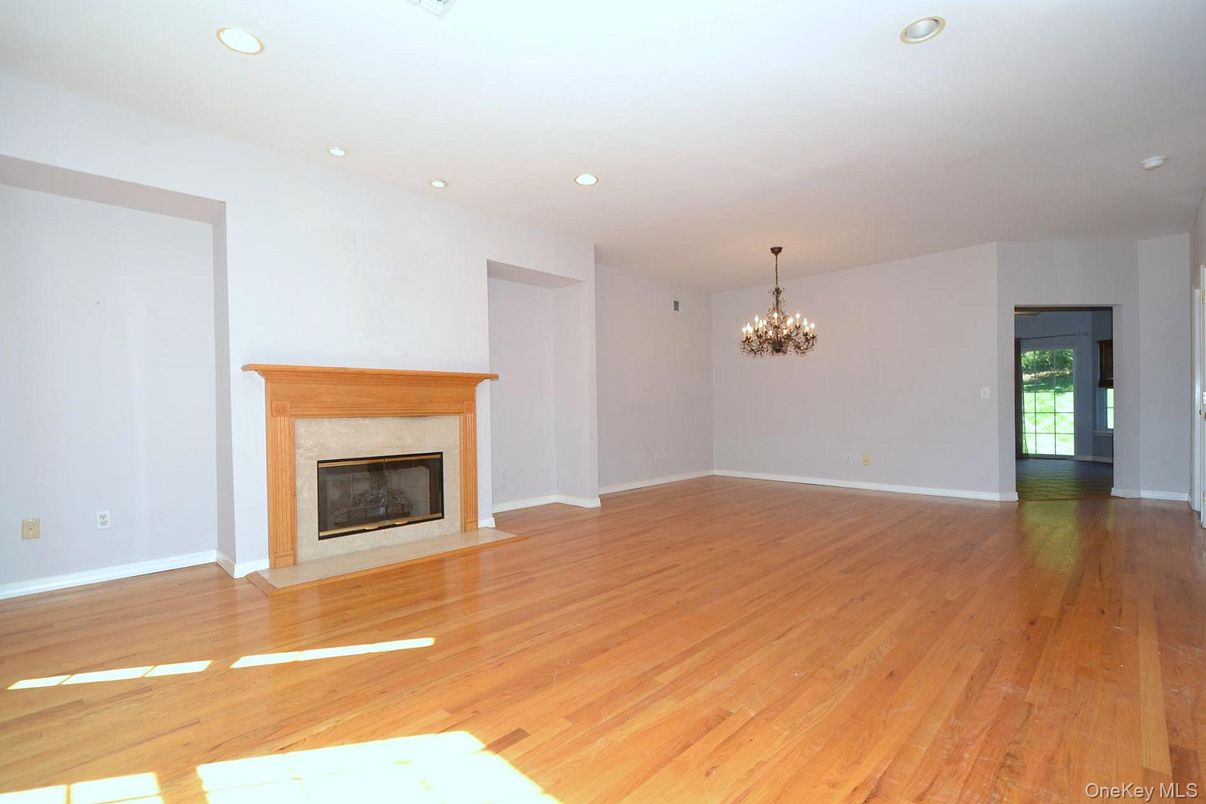 Chandelier, Empty room, Fireplace, Interior, Recessed Lighting, Wood Texture Flooring
