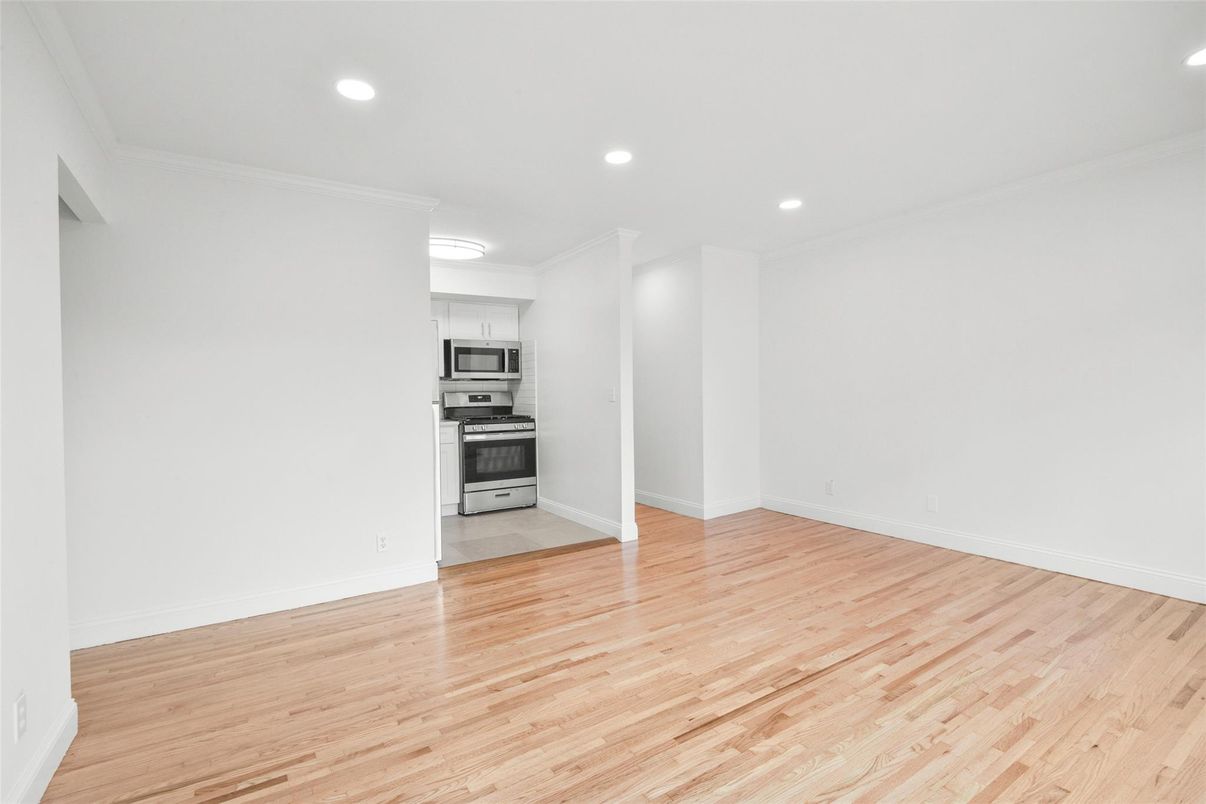 Empty room, Interior, Kitchen, Recessed Lighting, Stainless Steel Appliances, Wood Texture Flooring