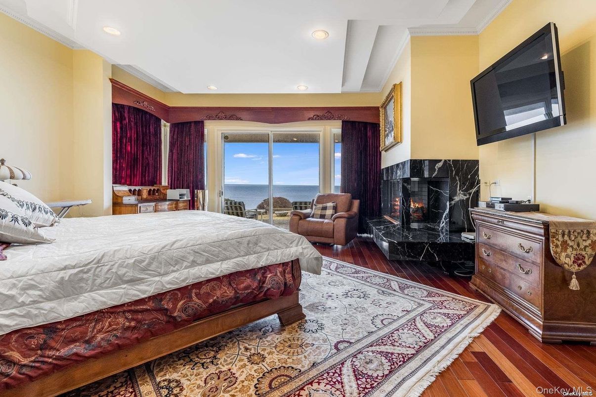 Bedroom, Fireplace, Interior, Recessed Lighting, Water, Wood Texture Flooring