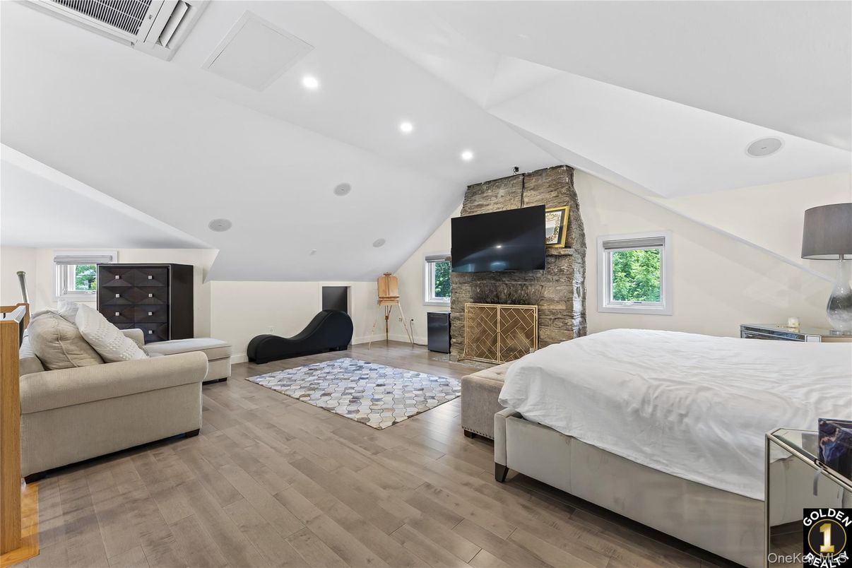 Bedroom, Fireplace, Interior, Recessed Lighting, Stone Walls, Wood Texture Flooring
