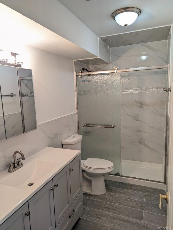 Bathroom, Glass Shower, Interior, Marble Walls, Wood Texture Flooring