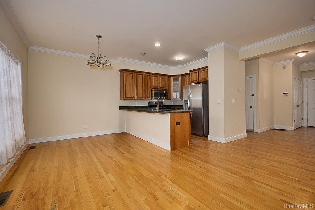 Empty room, Interior, Kitchen, Pendant Lights, Recessed Lighting, Stainless Steel Appliances, Wood Texture Flooring