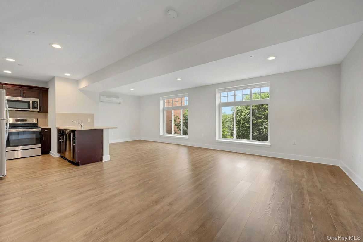 Empty room, Interior, Kitchen, Recessed Lighting, Stainless Steel Appliances, Wood Texture Flooring