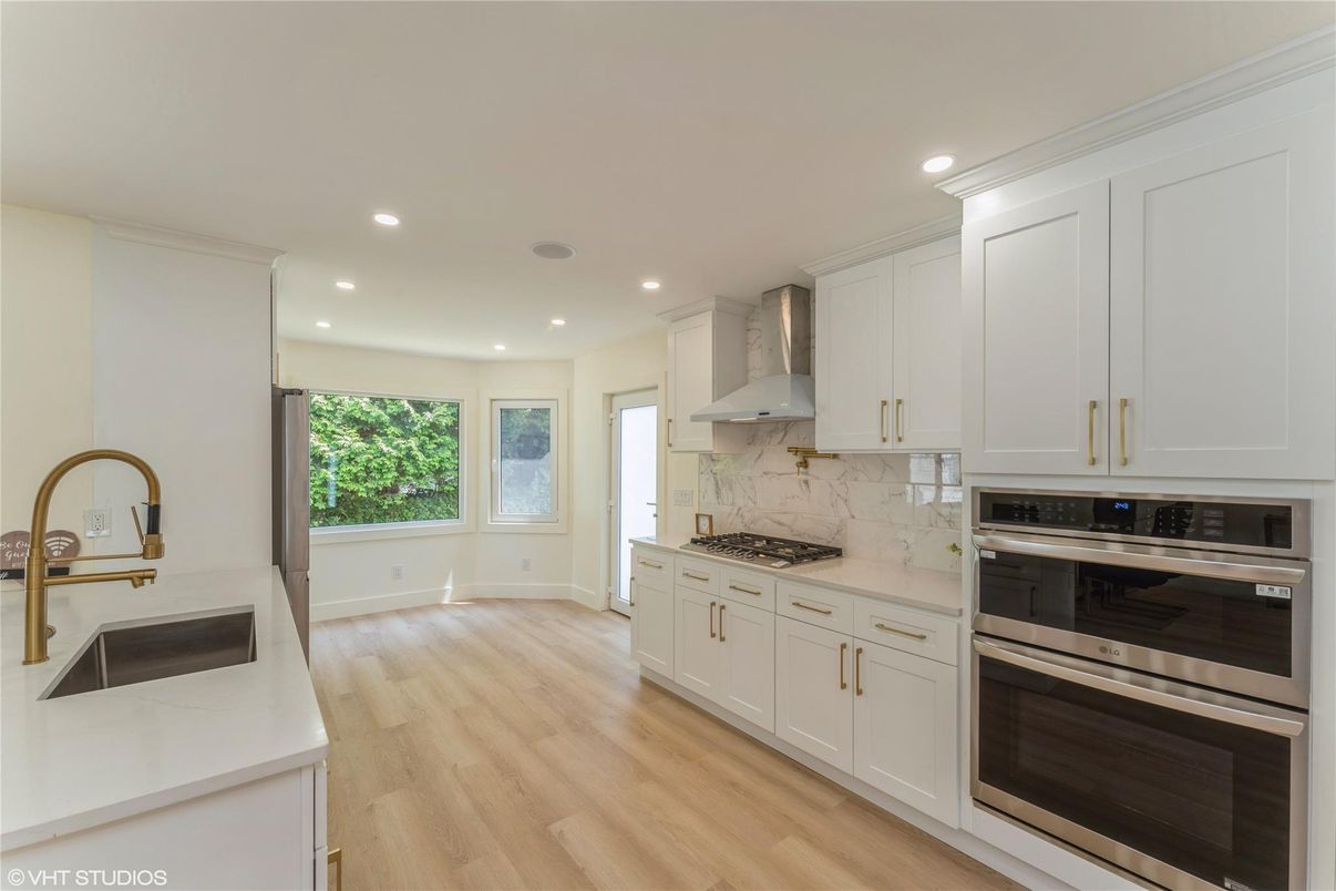 Interior, Kitchen, Marble Walls, Recessed Lighting, Stainless Steel Appliances, Wood Texture Flooring