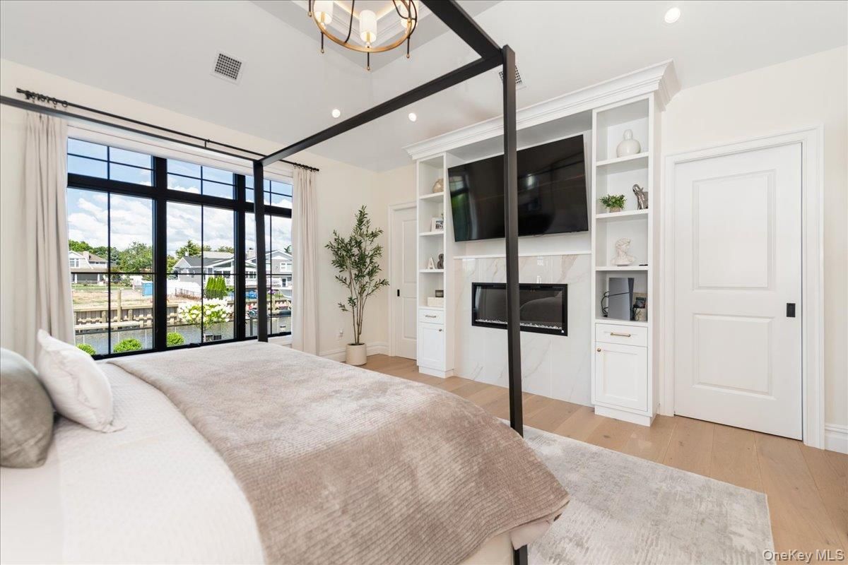 Bedroom, Fireplace, Interior, Recessed Lighting, Wood Texture Flooring