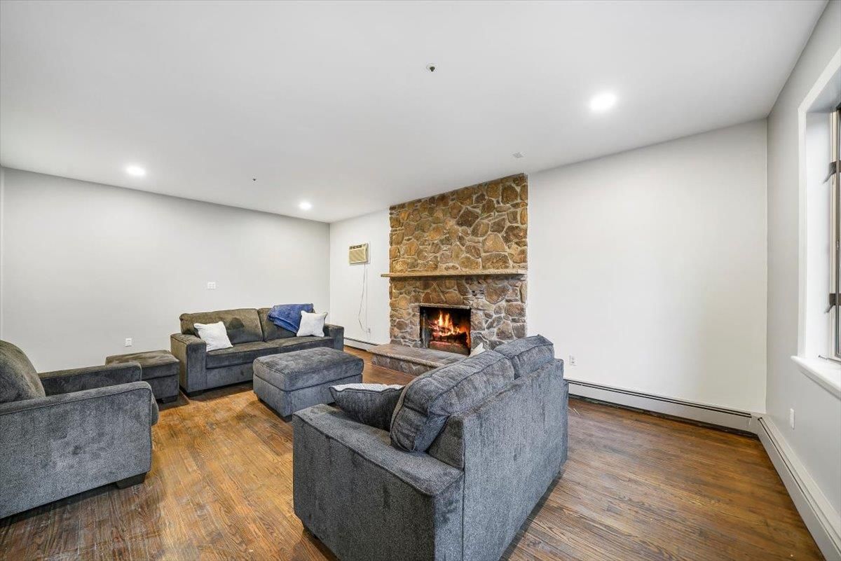 Fireplace, Interior, Living room, Recessed Lighting, Stone Walls, Wood Texture Flooring