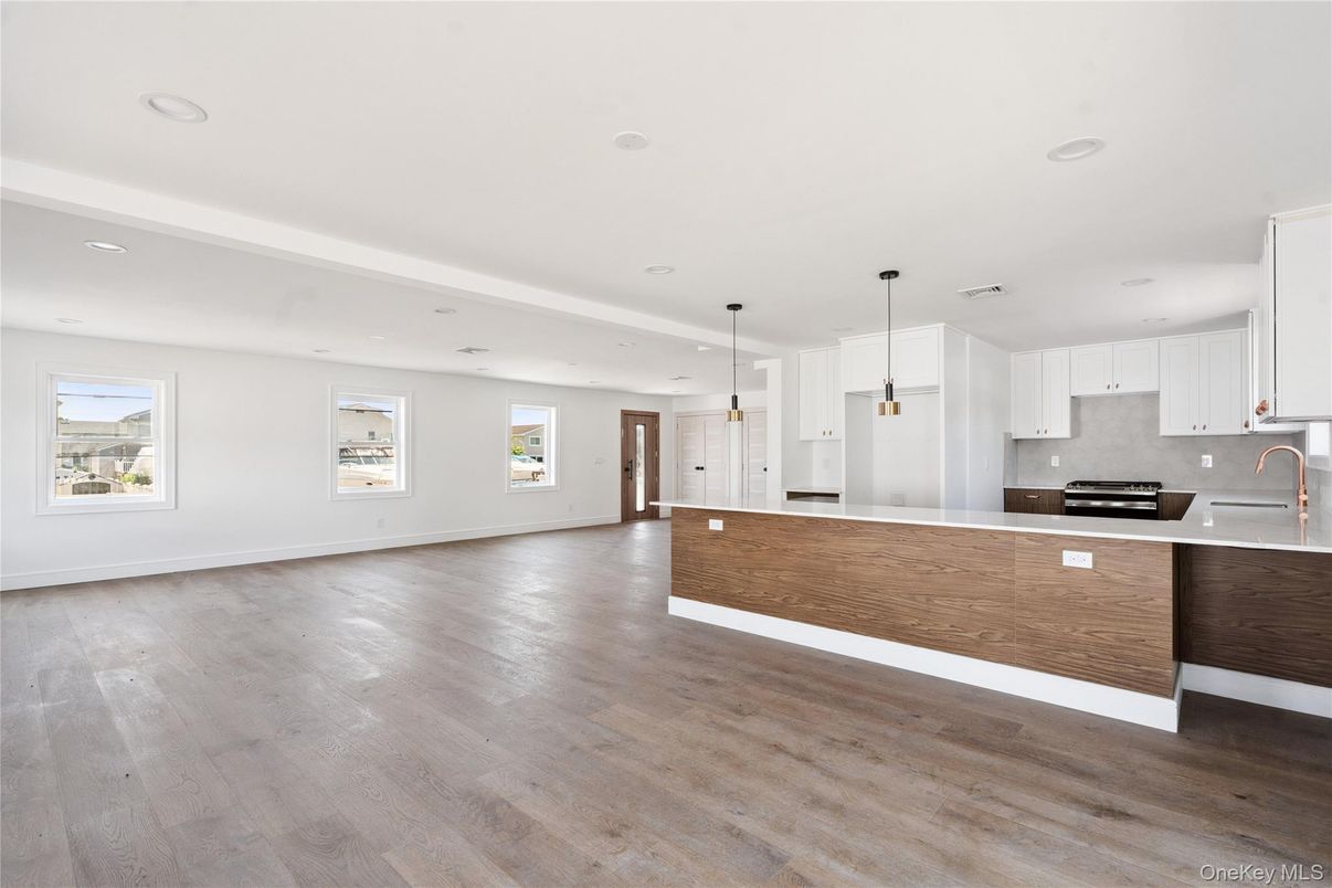 Empty room, Interior, Kitchen, Pendant Lights, Recessed Lighting, Stainless Steel Appliances, Wood Texture Flooring