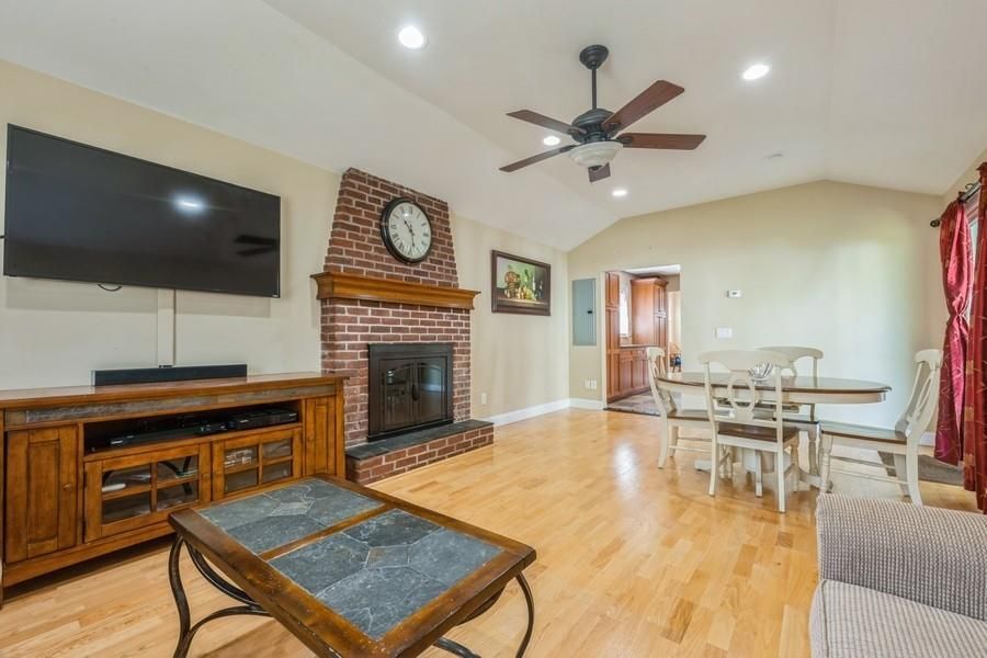 Dining room, Fireplace, Interior, Recessed Lighting, Stone Walls, Wood Texture Flooring