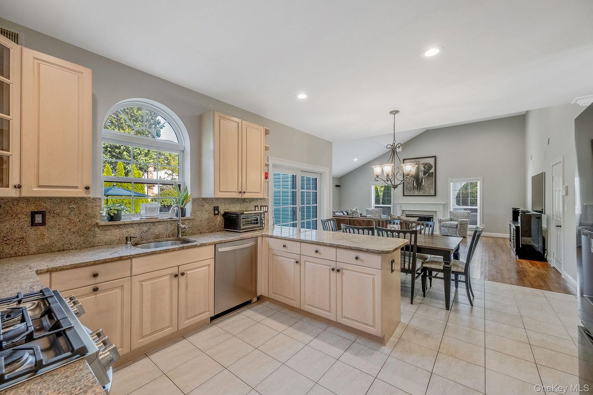 Chandelier, Dining room, Fireplace, Interior, Kitchen, Recessed Lighting, Stainless Steel Appliances, Wood Texture Flooring