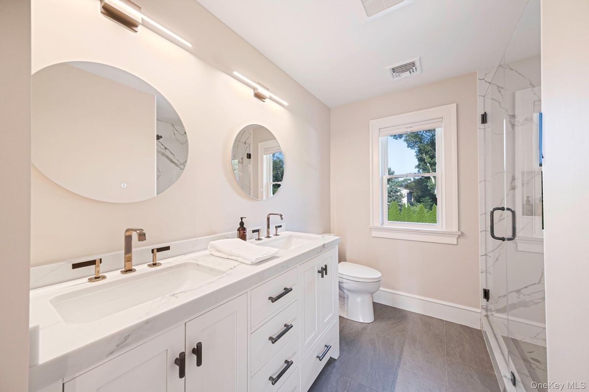 Bathroom, Dual Sink Vanities, Glass Shower, Interior, Marble Walls, Wood Texture Flooring