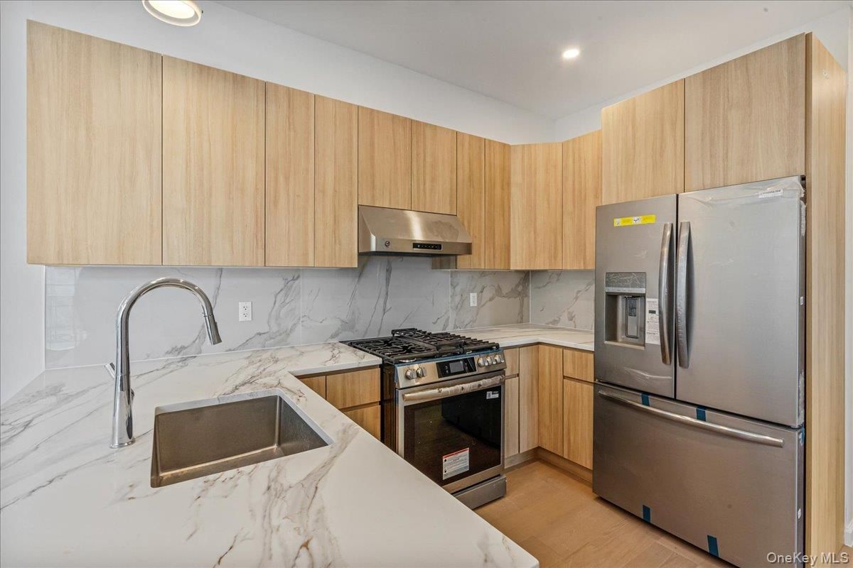 Interior, Kitchen, Marble Walls, Recessed Lighting, Stainless Steel Appliances, Wood Texture Flooring
