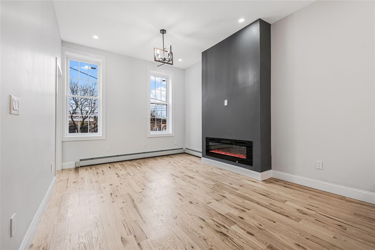 Empty room, Fireplace, Interior, Pendant Lights, Recessed Lighting, Wood Texture Flooring