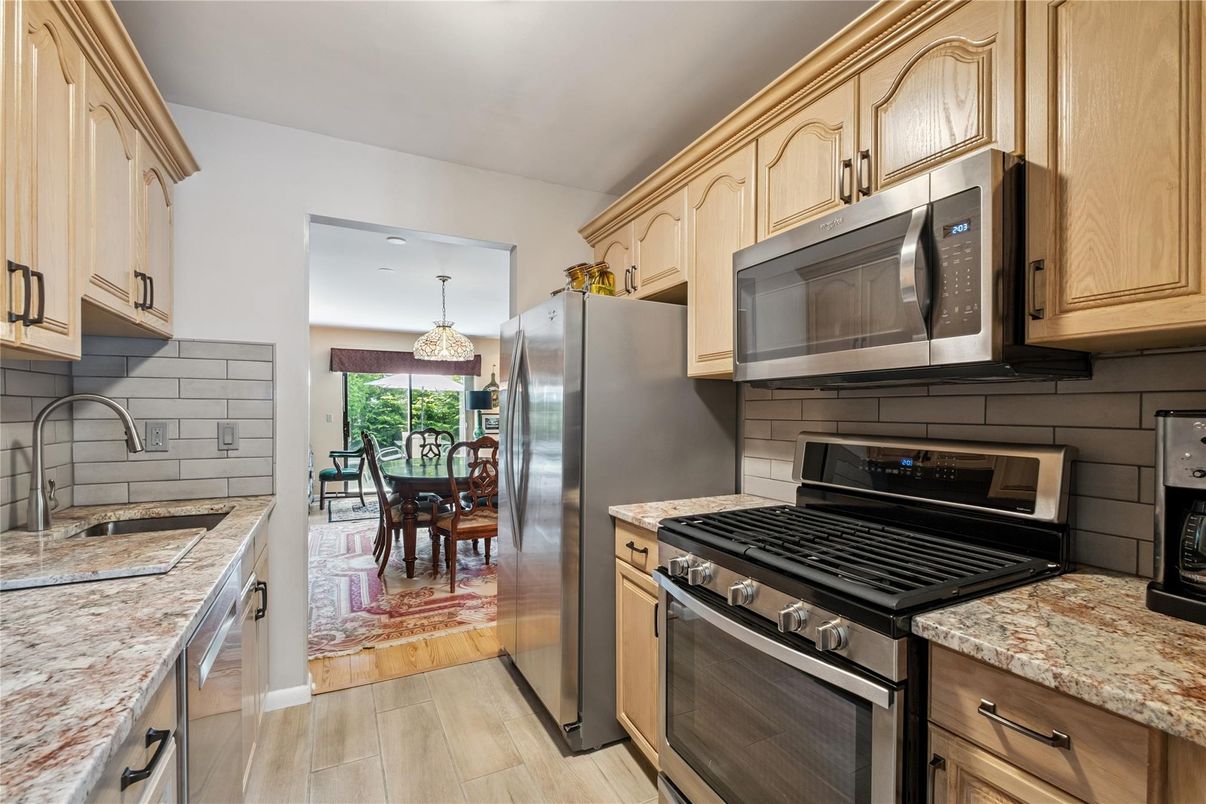 Chandelier, Dining room, Interior, Kitchen, Pendant Lights, Recessed Lighting, Stainless Steel Appliances, Wood Texture Flooring