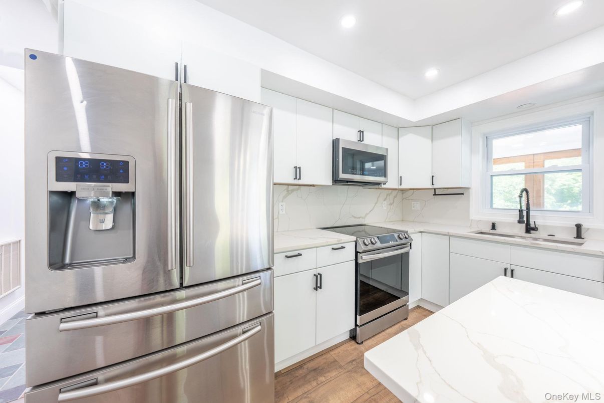 Interior, Kitchen, Marble Walls, Recessed Lighting, Stainless Steel Appliances, Wood Texture Flooring