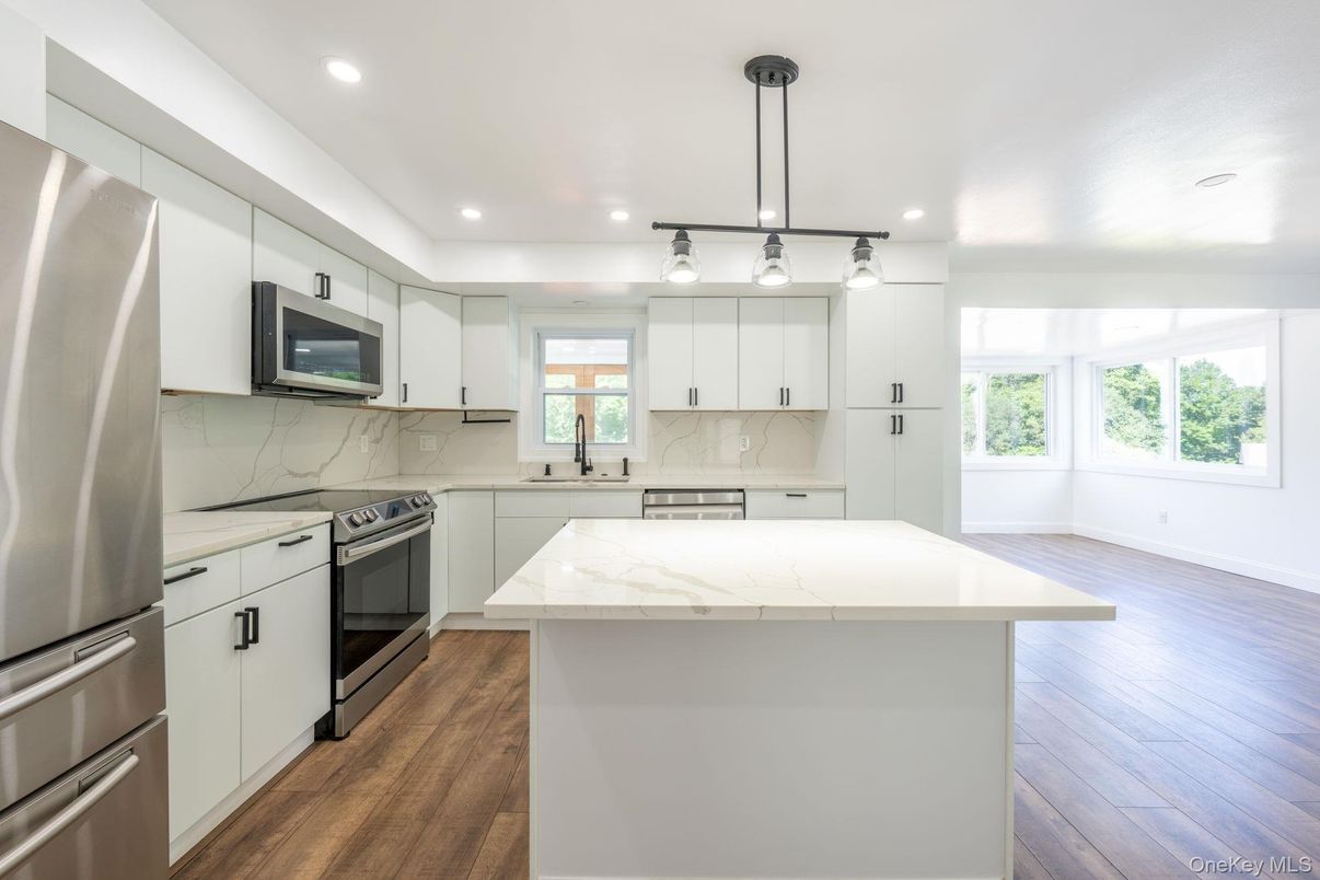 Interior, Kitchen, Marble Walls, Pendant Lights, Recessed Lighting, Stainless Steel Appliances, Wood Texture Flooring