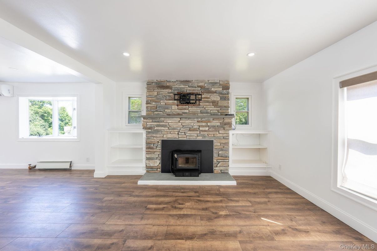Empty room, Fireplace, Interior, Recessed Lighting, Stone Walls, Wood Texture Flooring