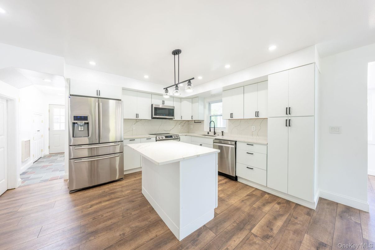 Interior, Kitchen, Marble Walls, Pendant Lights, Recessed Lighting, Stainless Steel Appliances, Wood Texture Flooring