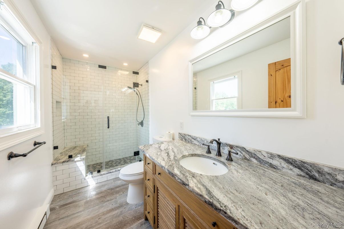Bathroom, Dual Sink Vanities, Glass Shower, Interior, Recessed Lighting, Wood Texture Flooring