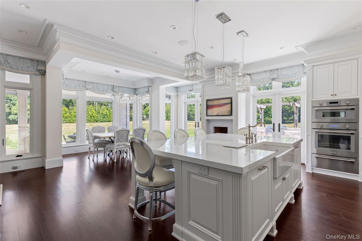 Chandelier, Dining room, Fireplace, Interior, Kitchen, Pendant Lights, Recessed Lighting, Stainless Steel Appliances, Wood Texture Flooring