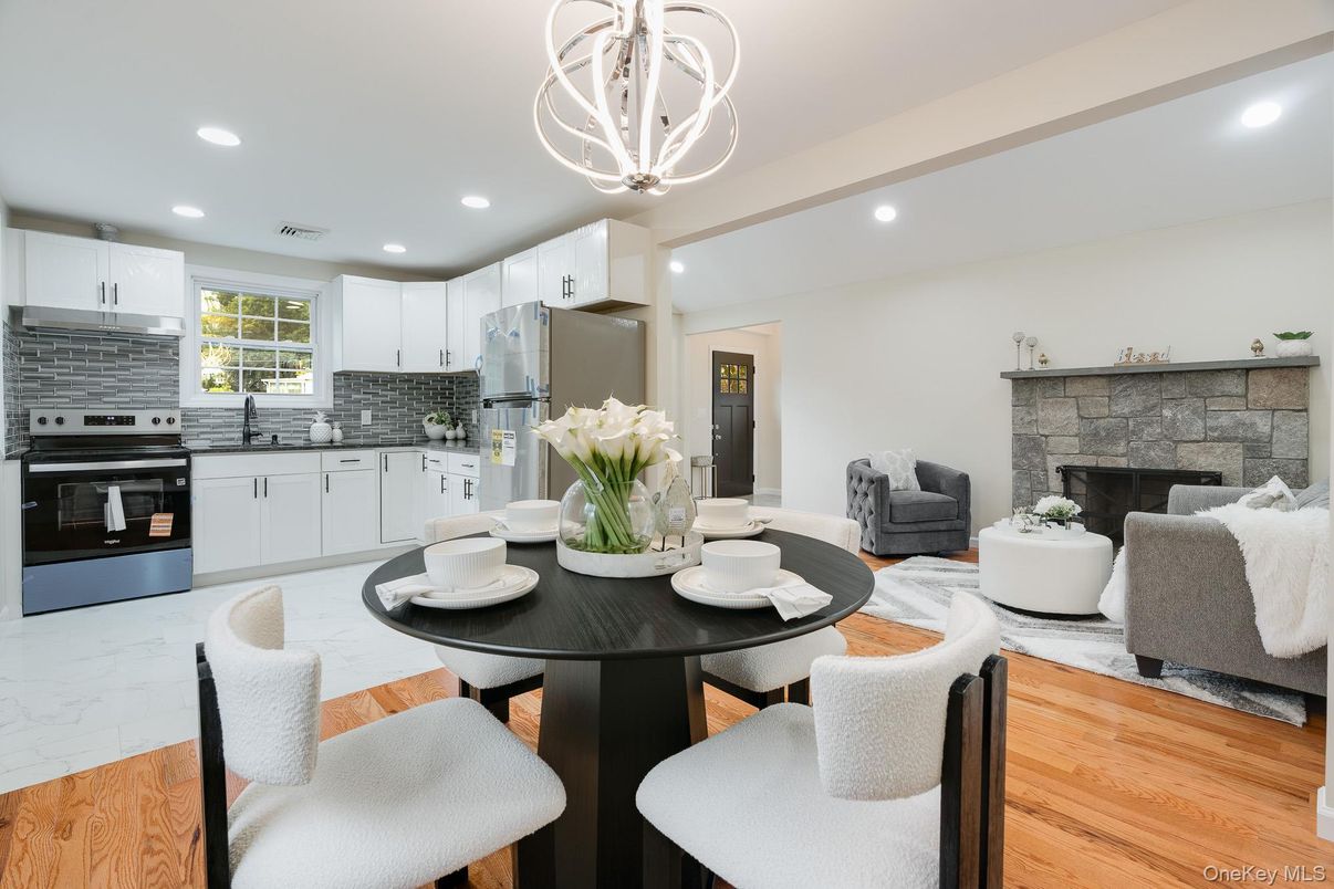 Chandelier, Dining room, Fireplace, Interior, Kitchen, Living room, Pendant Lights, Recessed Lighting, Stainless Steel Appliances, Wood Texture Flooring