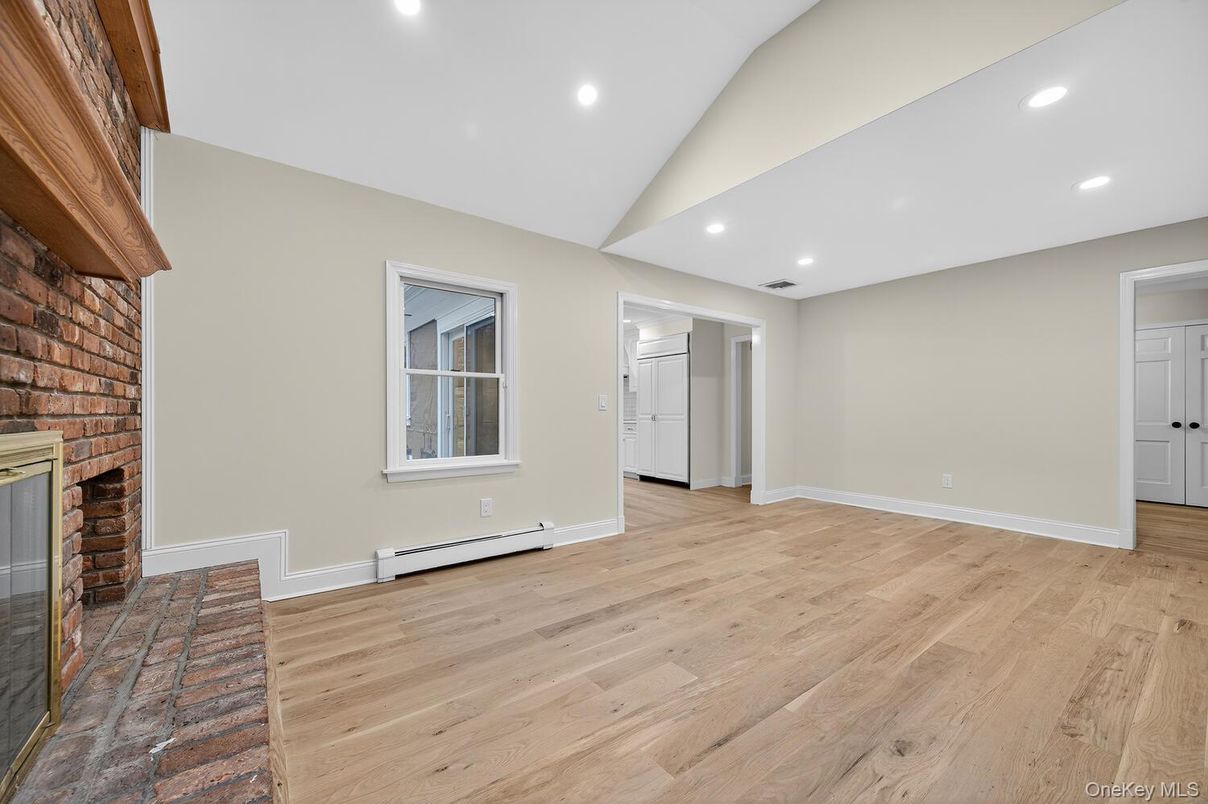 Empty room, Fireplace, Interior, Recessed Lighting, Stone Walls, Wood Texture Flooring