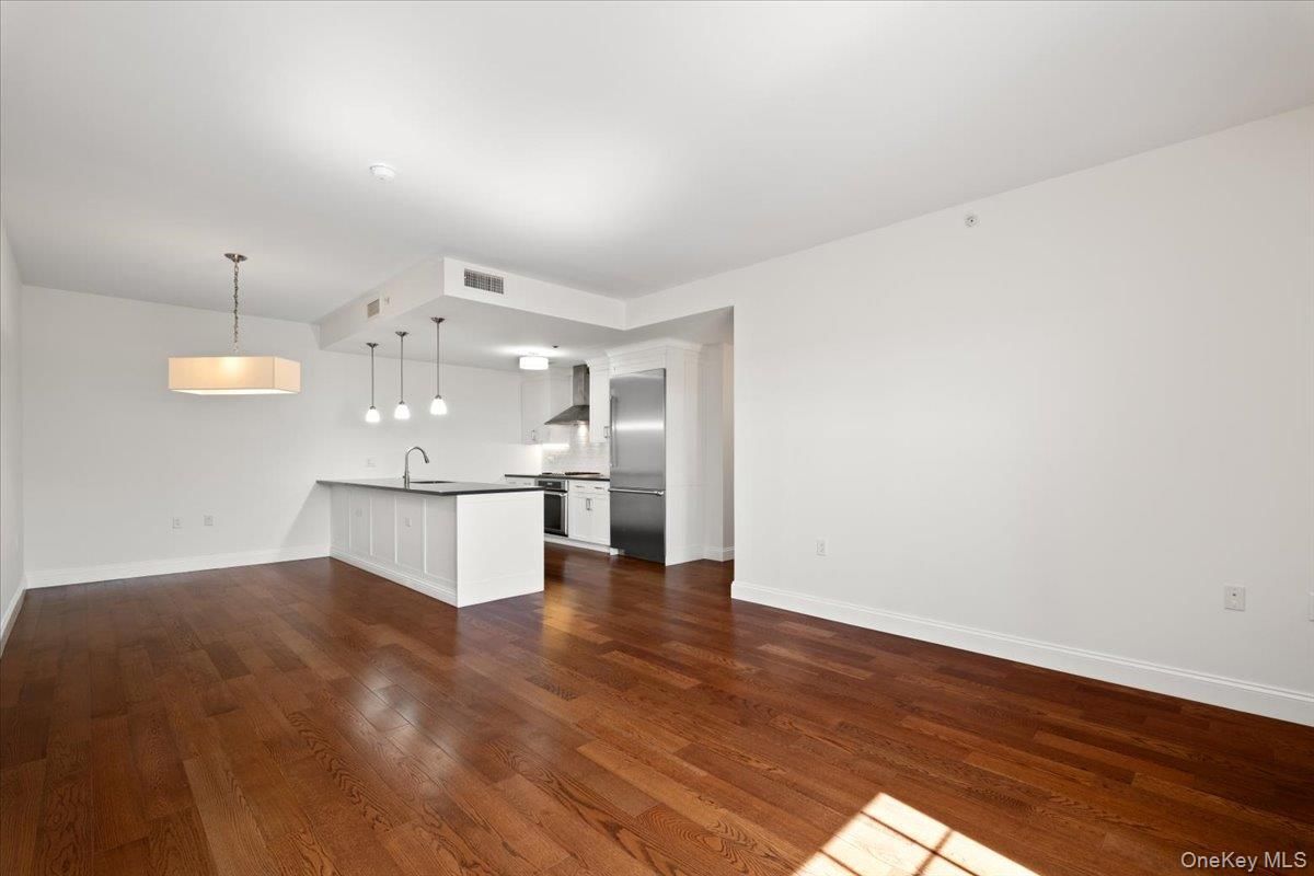 Empty room, Interior, Kitchen, Pendant Lights, Stainless Steel Appliances, Wood Texture Flooring