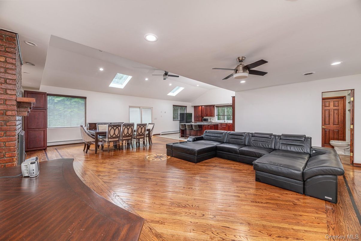 Dining room, Fireplace, Interior, Living room, Recessed Lighting, Stone Walls, Wood Texture Flooring