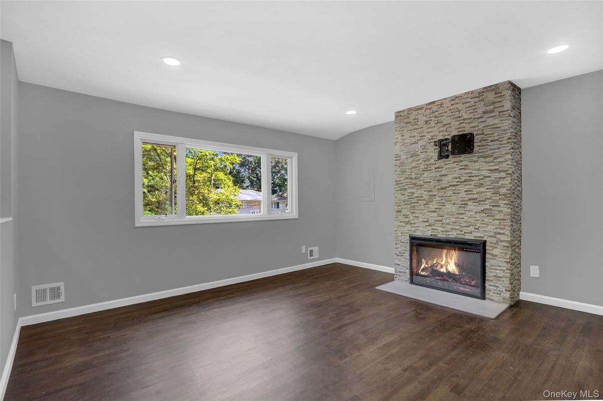 Empty room, Fireplace, Interior, Recessed Lighting, Stone Walls, Wood Texture Flooring