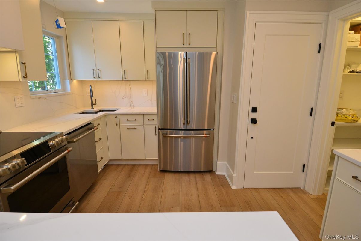 Interior, Kitchen, Marble Walls, Recessed Lighting, Stainless Steel Appliances, Wood Texture Flooring