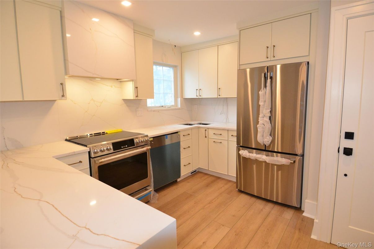 Interior, Kitchen, Marble Walls, Recessed Lighting, Stainless Steel Appliances, Wood Texture Flooring